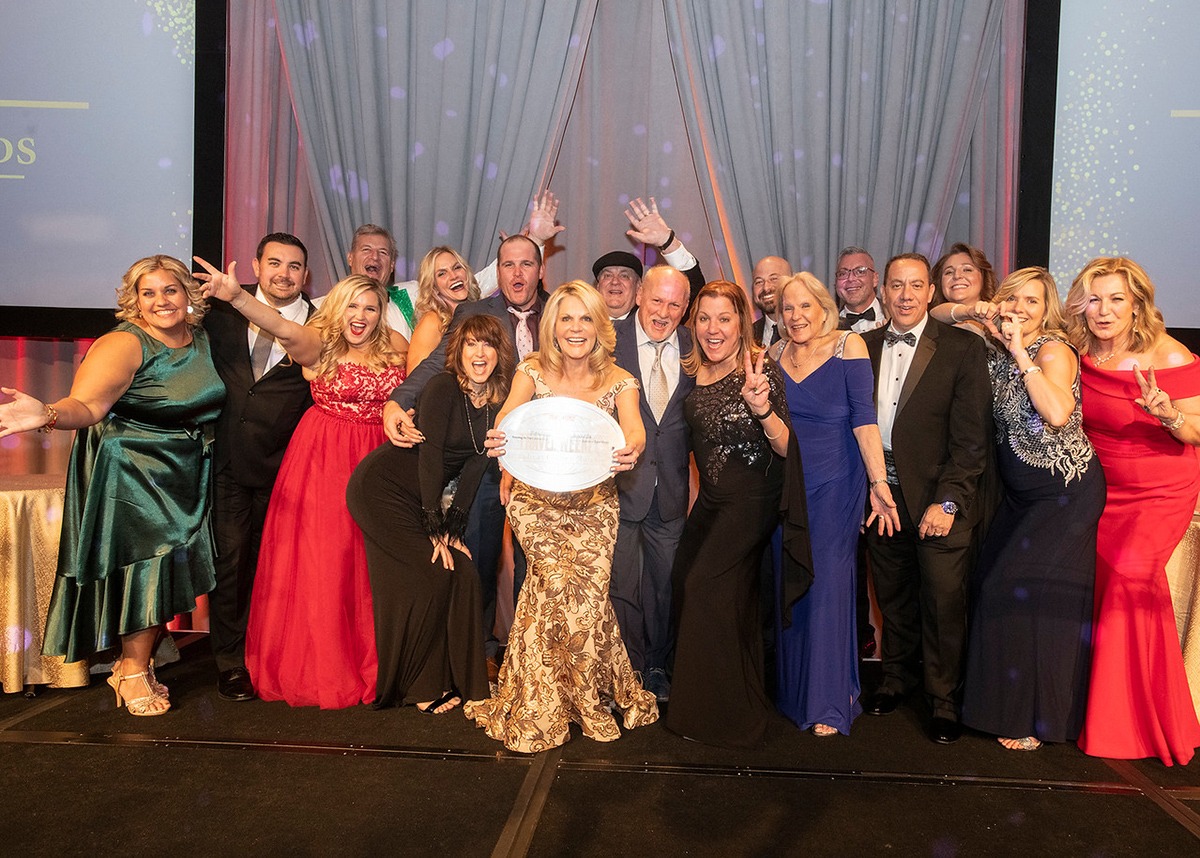 Michelle Fee surrounded by loved ones after being honored with Lifetime Achievement Award